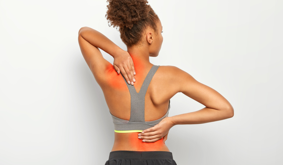 faceless-curly-woman-suffers-from-spine-pain-wears-sport-bra-shows-location-inflammation-isolated-white-background